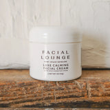 Luxe Calming Facial Cream Ultra Rich Hydrating Cream Facial Lounge Lifestyle on Wooden Log